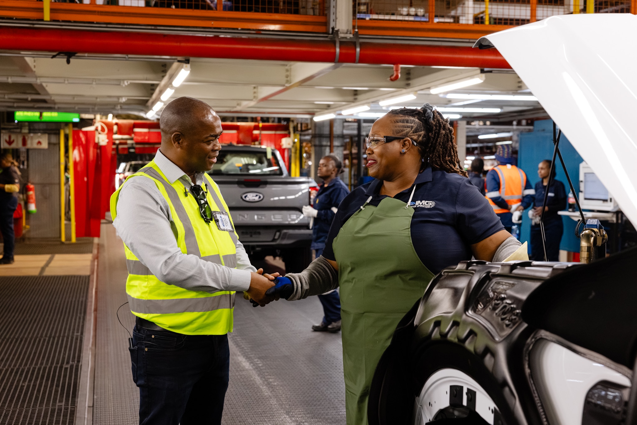 Moshoeshoe Monare, Primedia’s Group Head of Corporate Affairs, meets a Ford employee during the EWN team’s visit to Silverton Assembly Plant.